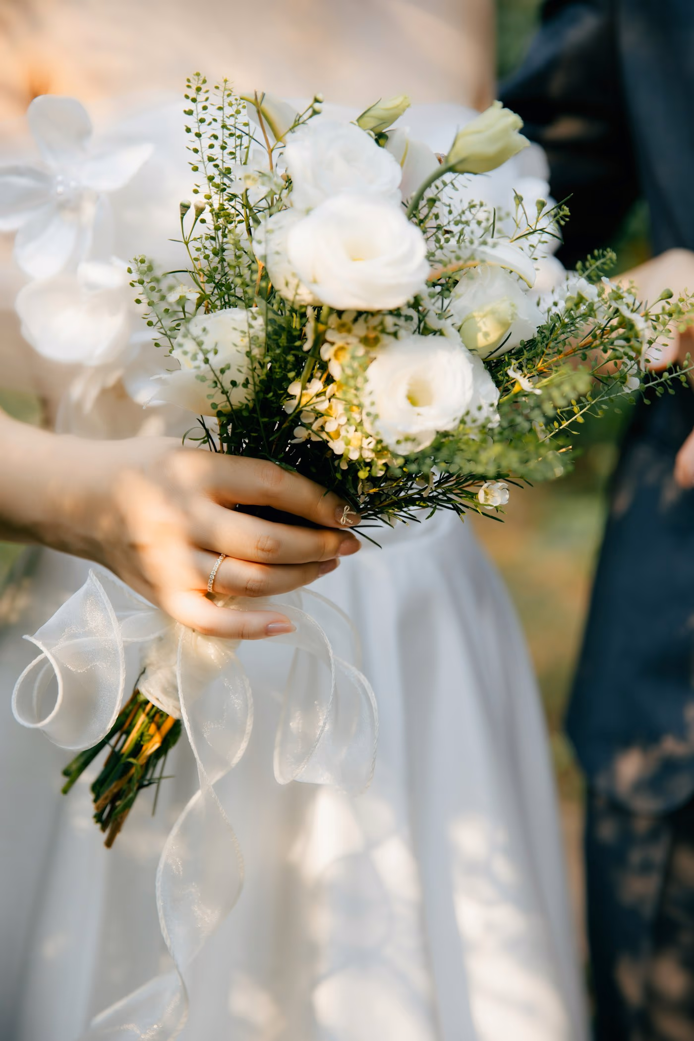 Détail d'un bouquet de mariée tenu à la main